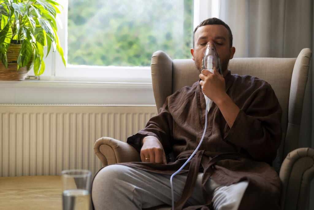 front view man using nebulizer