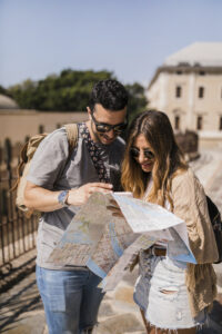 stylish young couple vacation looking map