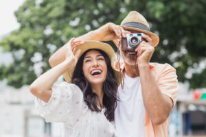 woman looking away while man photographing